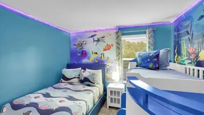 a childs room with a bed and a crib at OMW2718 in Kissimmee