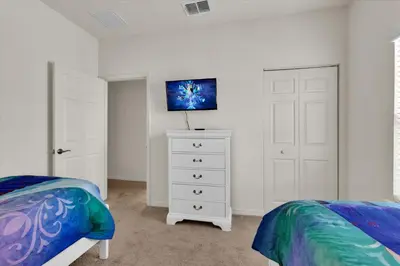 a bedroom with two beds and a white dresser at GDL3206 in Kissimmee