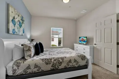 a bedroom with a white bed and a window at GDL3206 in Kissimmee