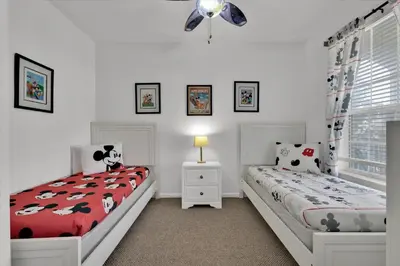 a bedroom with two beds and a ceiling fan at ALM2785-304 in Orlando