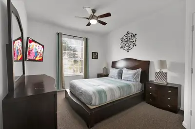 a bedroom with a bed and a dresser and a mirror at ALM2785-304 in Orlando