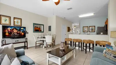 a living room with a couch and a dining room at SKC7653 in Orlando
