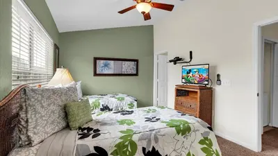a bedroom with a bed and a flat screen tv at SKC7653 in Orlando