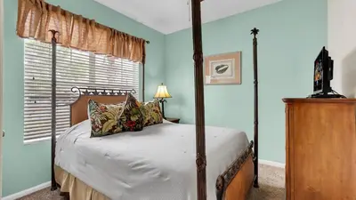 a bedroom with a four poster bed and a window at SKC7653 in Orlando