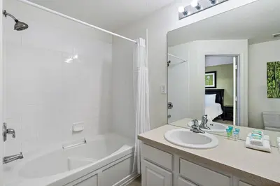a bathroom with a white tub and a sink and a bath tub at MSW2563 in Orlando