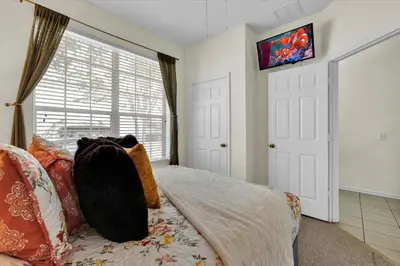 a bedroom with a bed and a large window at SKC7644 in Orlando