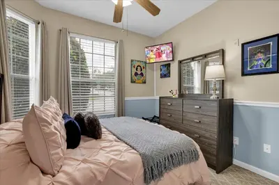 a bedroom with a bed and a dresser and a mirror at SPD2302-103 in Kissimmee