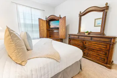 a bedroom with a bed with a mirror and a dresser at SPD2304-205 in Kissimmee