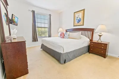 a bedroom with a bed and a dresser and a window at SPD2304-205 in Kissimmee