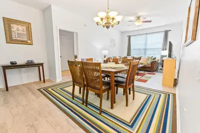 a dining room and living room with a table and chairs at SPD2304-205 in Kissimmee
