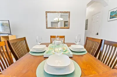 a dining room with a wooden table with chairs at SPD2304-205 in Kissimmee