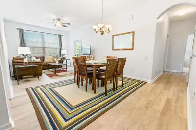 a dining room and living room with a table and chairs at SPD2304-205 in Kissimmee