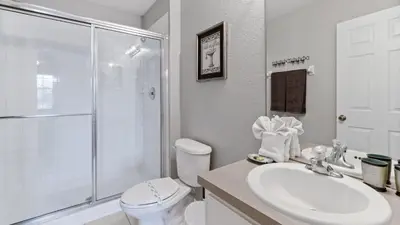 a bathroom with a toilet and a sink and a shower at DB2644 Windsor Hills Resort 6 Bedroom in Orlando