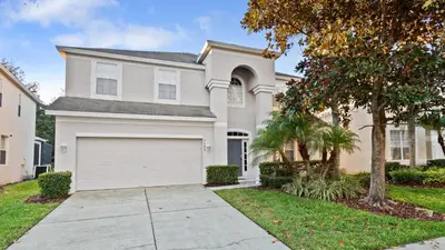 a large white house with a garage at DB2644 Windsor Hills Resort 6 Bedroom in Orlando