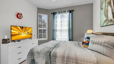 a bedroom with a bed with a tv on it at BF2302-203 Windsor Palms Resort 3 Bedroom in Kissimmee