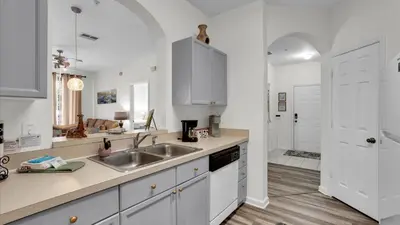 a kitchen with white cabinets and a sink at BF2302-203 Windsor Palms Resort 3 Bedroom in Kissimmee