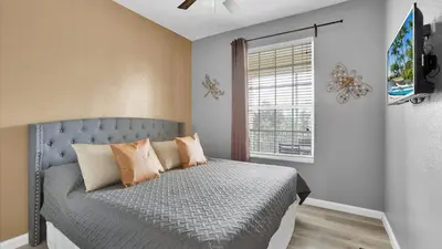a bedroom with a bed with pillows and a window at BF2301-301 Windsor Palms Resort 3 Bedroom in Kissimmee