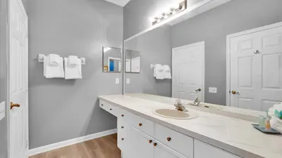 a white bathroom with a sink and a mirror at BF2301-301 Windsor Palms Resort 3 Bedroom in Kissimmee