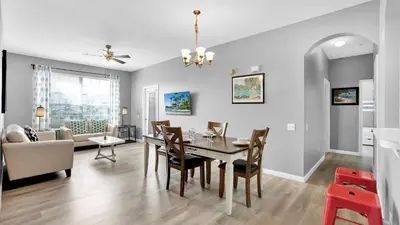 a dining room and living room with a table and chairs at BF2301-301 Windsor Palms Resort 3 Bedroom in Kissimmee