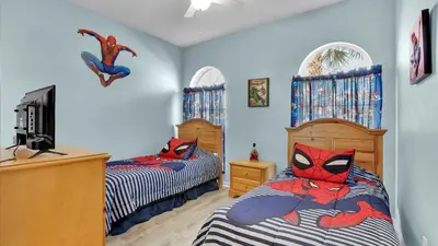 a bedroom with two beds and a spiderman sign on the wall at KP8034 Windsor Palms Resort 4 Bedroom Private Pool in Kissimmee