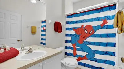 a bathroom with a spider man shower curtain at KP8034 Windsor Palms Resort 4 Bedroom Private Pool in Kissimmee