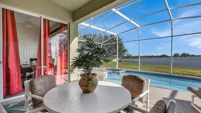 a table with a potted plant sitting on top of a patio at KP8034 Windsor Palms Resort 4 Bedroom Private Pool in Kissimmee