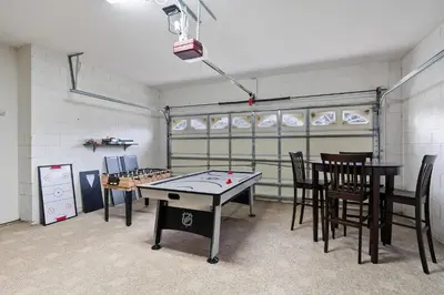 a room with a ping pong table and chairs at KP8034 Windsor Palms Resort 4 Bedroom Private Pool in Kissimmee