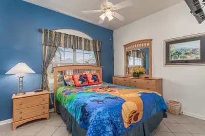 a bedroom with a bed and a ceiling fan at WP2217 Windsor Palms Resort 4 Bedroom Private Pool in Kissimmee