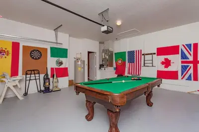 a pool table in a room with flags of different countries at WP2217 Windsor Palms Resort 4 Bedroom Private Pool in Kissimmee