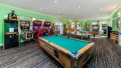 a games room with a pool table and arcade machines at WP2217 Windsor Palms Resort 4 Bedroom Private Pool in Kissimmee