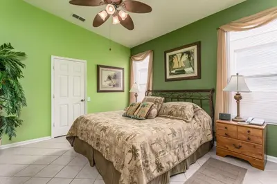a green bedroom with a bed and a ceiling fan at WP2217 Windsor Palms Resort 4 Bedroom Private Pool in Kissimmee