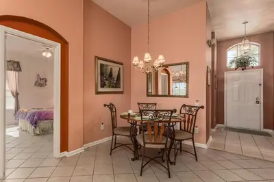 a dining room with a table and chairs at WP2217 Windsor Palms Resort 4 Bedroom Private Pool in Kissimmee