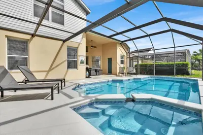 a swimming pool with a pergola on a house at SP8131 Windsor Palms Resort 6 Bedroom in Kissimmee