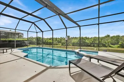 an indoor swimming pool with a large glass ceiling at SP8131 Windsor Palms Resort 6 Bedroom in Kissimmee