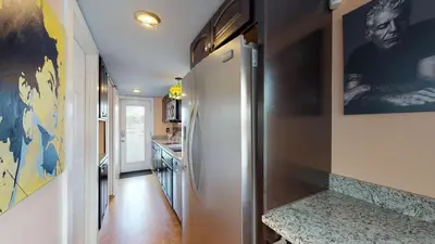 a hallway with a white refrigerator in a kitchen at The Famous Houseboat in Sanford in Sanford