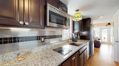 a kitchen with a sink and a counter top at The Famous Houseboat in Sanford in Sanford