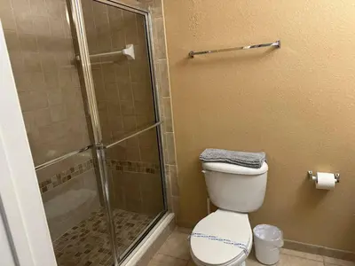 a bathroom with a shower stall and a toilet at Cozy condo Just a few minutes from Disney in Kissimmee
