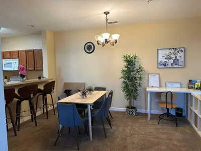 a dining room and kitchen with a table and chairs at Cozy condo Just a few minutes from Disney in Kissimmee