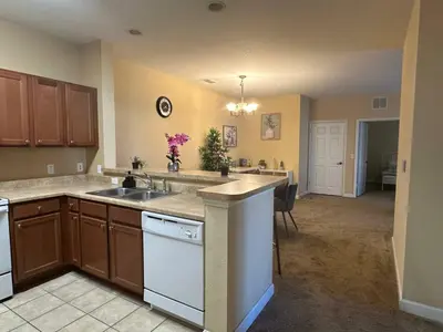 a kitchen with a sink and a counter top at Cozy condo Just a few minutes from Disney in Kissimmee