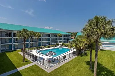 an aerial view of a hotel with a pool and palm trees at Palm Tree Inn Altamonte Springs Orlando in Orlando