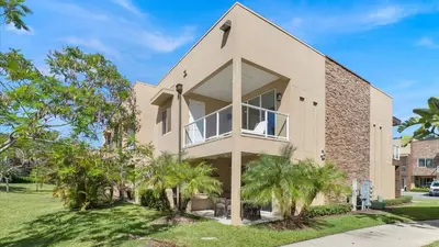 a house with a large window and palm trees at RCF7646 in Orlando