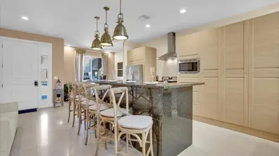 a kitchen with a bar with chairs and a counter at RCF7646 in Orlando