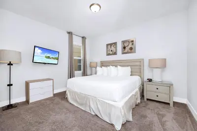 a white bedroom with a large bed and two lamps at Charming Home With Private Pool, Theme Rooms And Foosball Table Near Disney With Waterpark & Resort Access At Encore - 370La in Kissimmee