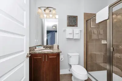 a bathroom with a toilet and a sink and a shower at Charming Home With Private Pool, Theme Rooms And Foosball Table Near Disney With Waterpark & Resort Access At Encore - 370La in Kissimmee