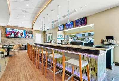 a bar in a restaurant with chairs and tables at Charming Home With Private Pool, Theme Rooms And Foosball Table Near Disney With Waterpark & Resort Access At Encore - 370La in Kissimmee