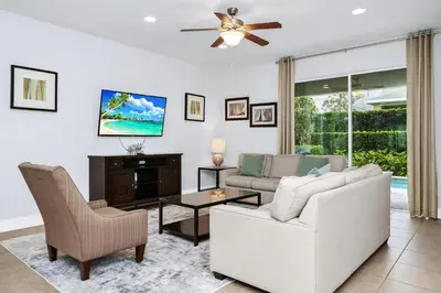 a living room with a couch and a table at Charming Home With Private Pool, Theme Rooms And Foosball Table Near Disney With Waterpark & Resort Access At Encore - 370La in Kissimmee