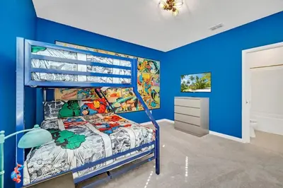 a bedroom with blue walls and a bunk bed at 2525 Shanti Amazing 15 Suites Mansion in Kissimmee