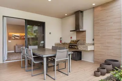 a kitchen with a table and chairs and a stove at Minutes to Disney Chic Dream Villa with Stunning Patio and Resort Perks in Orlando