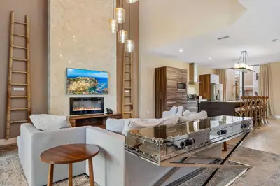 a living room with a couch and a table at Minutes to Disney Chic Dream Villa with Stunning Patio and Resort Perks in Orlando