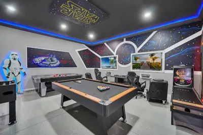 a gaming room with a pool table and arcade machines at Getaway Cove Villa in Orlando